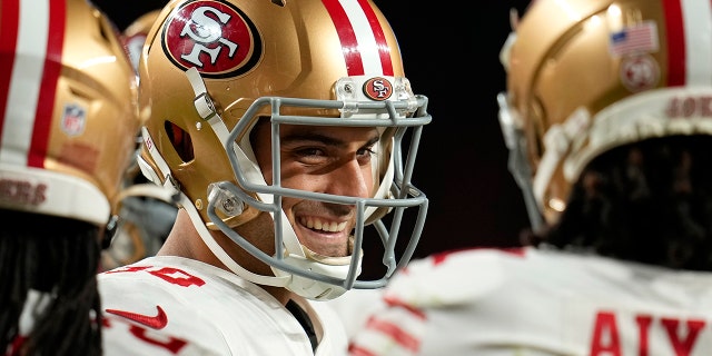 San Francisco 49ers quarterback Jimmy Garoppolo smiles in the huddle during the first half of a game against the Denver Broncos in Denver, Sunday, Sept. 25, 2022.