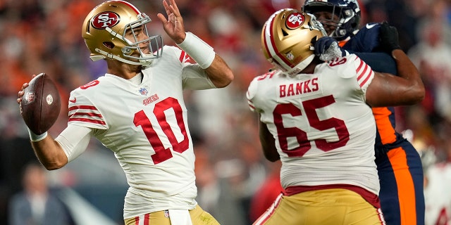 San Francisco 49ers quarterback Jimmy Garoppolo (10) passes against the Denver Broncos during the first half of an NFL football game in Denver, Sunday, Sept. 25, 2022.