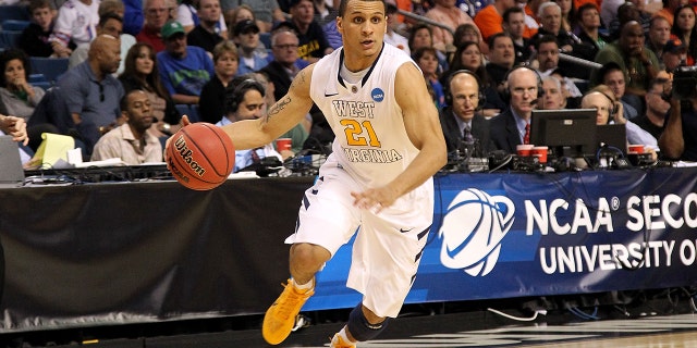Joe Mazzulla of the West Virginia Mountaineers drives against the Clemson Tigers during the second round of the 2011 NCAA men's basketball tournament in Tampa, Florida, on March 17, 2011.