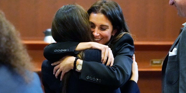 Attorney Joelle Rich hugs attorney Camille Vasquez, back to camera, at the Fairfax County Circuit Courthouse in Fairfax, Virginia, at Johnny Depp-Amber Hear trial.