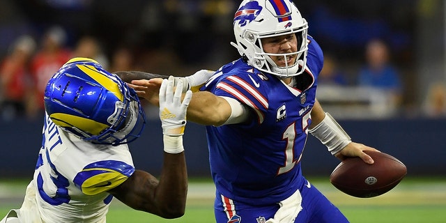 Quarterback Josh Allen #17 of the Buffalo Bills rushes the football against safety Nick Scott #33 of the Los Angeles Rams during the third quarter of the NFL game at SoFi Stadium on September 08, 2022 in Inglewood, California.