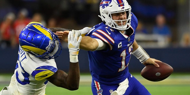 Buffalo Bills quarterback Josh Allen #17 pitches a football against Los Angeles Rams safety Nick Scott #33 during the third quarter of an NFL game at SoFi Stadium in Inglewood, California on September 8, 2022. hurry up