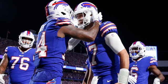 Buffalo Bills' Stefon Diggs, second from left, celebrates with quarterback Josh Allen, second from right, after they connected for a touchdown during the second half of an NFL football game against the Tennessee Titans, Monday, Sept. 19, 2022, in Orchard Park, New York.