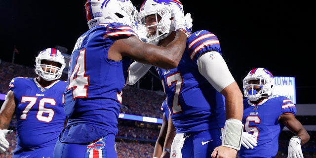 Buffalo Bills' Stefon Diggs, second from left, celebrates with quarterback Josh Allen, second from right, after they connected for a touchdown during the second half of an NFL football game against the Tennessee Titans, Monday, Sept. 19, 2022, in Orchard Park, New York.