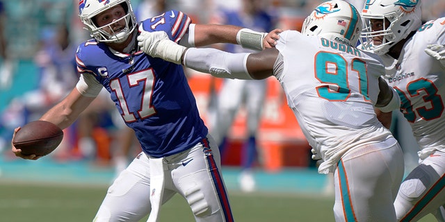 Miami Dolphins defensive end Emmanuel Ogbah, #91, grabs Buffalo Bills quarterback Josh Allen, #17, during the second half of an NFL football game, Sunday, Sept. 25, 2022, in Miami Gardens, Florida. 