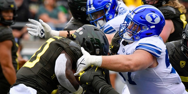 BYU defensive lineman Josh Larsen stops Oregon running back Mar'Keise Irvin, Saturday, Sept. 17, 2022.