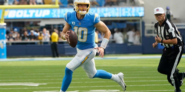 Los Angeles Chargers quarterback Justin Herbert (10) rolls out during the second half of an NFL football game against the Jacksonville Jaguars in Inglewood, Calif., Sunday, Sept. 25, 2022.