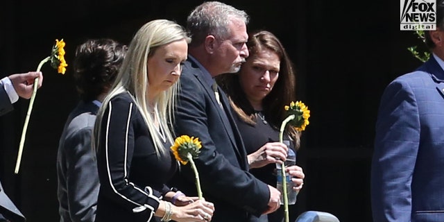 Slain Louisiana State University student Allison Rice's parents, Paul Rice (middle) and Angela Engler (left) leaving their daughter's funeral Wednesday, September 21, 2022, at St. John the Evangelist in Prairieville, Louisiana.