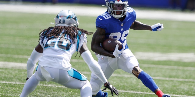 New York Giants' Kadarius Toney, right, runs with the ball during the first half an NFL football game against the Carolina Panthers, Sunday, Sept. 18, 2022, in East Rutherford, New Jersey.