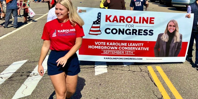 Republican congressional candidate Karoline Leavitt marches in a parade in Gilford, New Hampshire on August 27, 2022