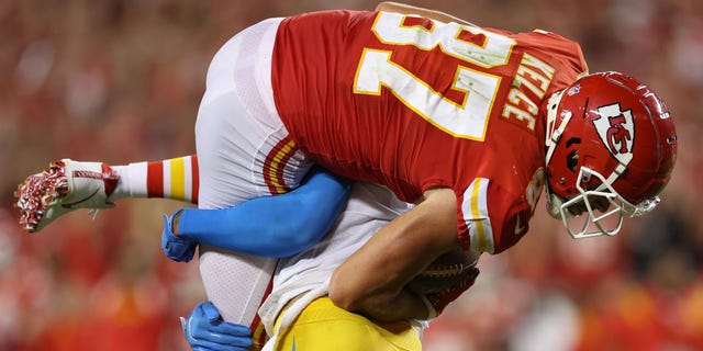 Derwin James Jr. of the Los Angeles Chargers lifts and slams Travis Kelce of the Kansas City Chiefs during the third quarter at Arrowhead Stadium in Kansas City on Sept. 15, 2022.