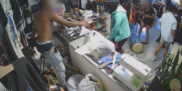 Security video inside a Los Angeles clothing store shows two suspects robbing a victim. One of the suspects was identified as Eric Watts.