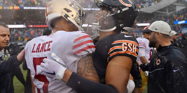 Trey Lance of the San Francisco 49ers and Justin Fields of the Chicago Bears embrace after the game at Soldier Field on Sept. 11, 2022.