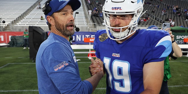 Matt White of New Orleans Breakers celebrates with head coach Larry Fedora after defeating the Philadelphia Stars 23-17 at Protective Stadium on April 17, 2022, in Birmingham, Alabama.