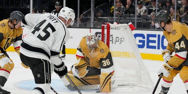 Vegas Golden Knights goaltender Logan Thompson (36) blocks a shot by Los Angeles Kings' Jacob Doty (45) during the first period of an NHL preseason hockey game Monday, Sept.  26, 2022, in Las Vegas.