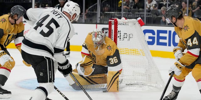 Vegas Golden Knights goaltender Logan Thompson (36) blocks a shot by Los Angeles Kings' Jacob Doty (45) during the first period of an NHL preseason hockey game Monday, Sept. 26, 2022, in Las Vegas.