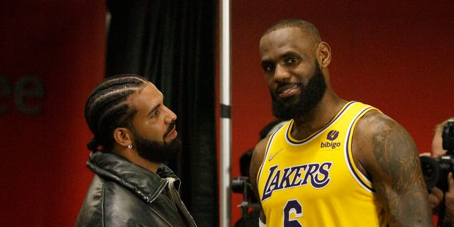 Drake and LeBron James #6 of the Los Angeles Lakers talk after the NBA game between the Toronto Raptors and the Los Angeles Lakers at Scotiabank Arena on March 18, 2022 in Toronto, Canada. 