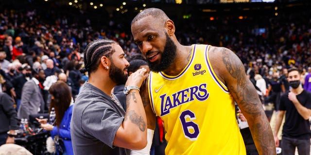 LeBron James #6 of the Los Angeles Lakers talks to rapper Drake after the game against the Toronto Raptors on March 18, 2022 at the Scotiabank Arena in Toronto, Ontario, Canada. 