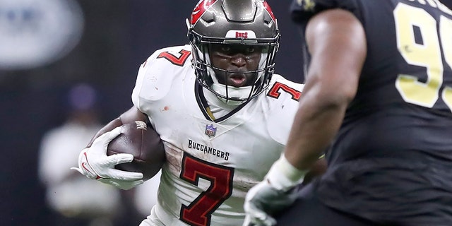 Tampa Bay Buccaneers running back Leonard Fournette, #7, holds the ball during the Buccaneers-New Orleans Saints regular season game on September 18, 2022 at the Caesars Superdome in New Orleans. 