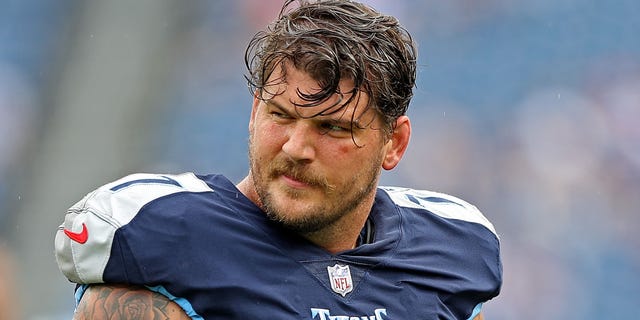 Taylor Lewan squints with helmet off