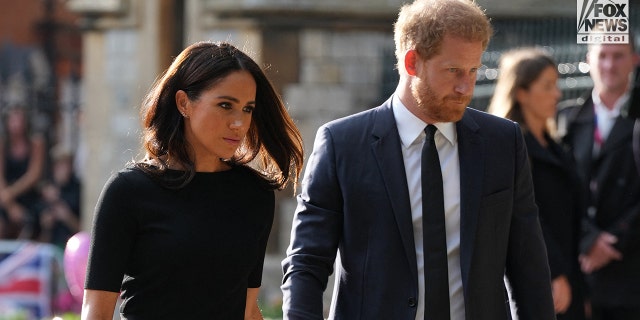 Downcast Meghan Markle in a black dress and Prince Harry in a black suit and black tie outside Windsor Castle after the Queen died