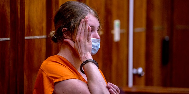 Courtney Clenney covers her face during an evidentiary hearing in Miami, Florida, on Sept. 6, 2022.