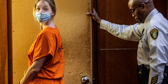 Courtney Clenney is escorted from the courtroom after a hearing Sept. 6, 2022.