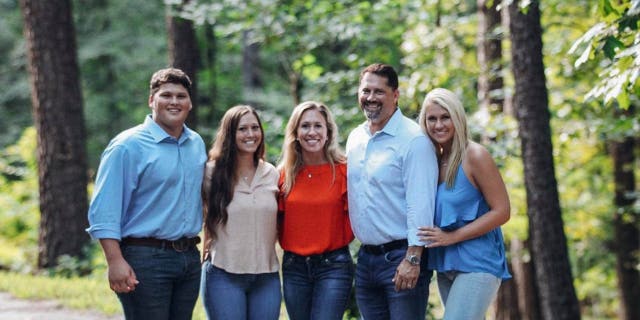 Rep. Marjorie Taylor Greene, R-Ga., poses for a picture with her husband Perry Greene and their three children in March 2020.