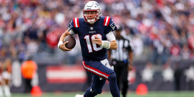 Quarterback Mac Jones of the New England Patriots runs the ball against the Baltimore Ravens at Gillette Stadium on Sept. 25, 2022, in Foxborough, Massachusetts.