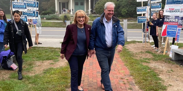 Democratic Sen. Maggie Hassan, along with her husband Tom, arrives at the Newfields, New Hampshire, to vote on primary day, on Sept. 13, 2022.