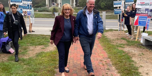 Democratic Sen. Maggie Hassan, along with her husband Tom, arrives at the Newfields, New Hampshire, to vote on primary day, on Sept. 13, 2022.