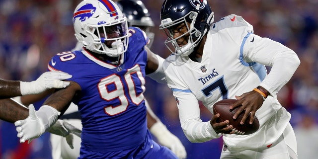 Malik Willis, #7 of the Tennessee Titans, scrambles against Shaq Lawson, #90 of the Buffalo Bills, during the third quarter of the game at Highmark Stadium on Sept. 19, 2022 in Orchard Park, New York.