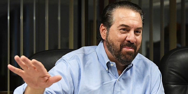 FILE - Arizona Attorney General Mark Brnovich gestures and smiles during his visit to the Yuma Sun in Yuma, Ariz., Thursday morning, June 2, 2022.