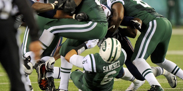 New York Jets quarterback Mark Sanchez, #6, fumbled in the first half when the New York Jets played the New England Patriots.