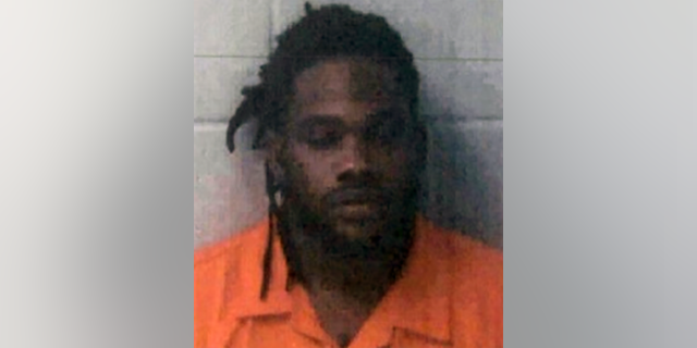 Marquez Smith turned himself in on murder charges in the shooting of his ex-wife and her boyfriend.