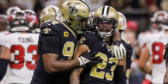 Saints defensive end Cameron Jordan consoles cornerback Marshon Lattimore after a match against Tampa Bay Buccaneers wide receiver Mike Evans in New Orleans on Sept. 18, 2022.