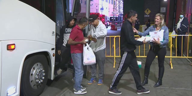 A migrant bus arrives in New York City.