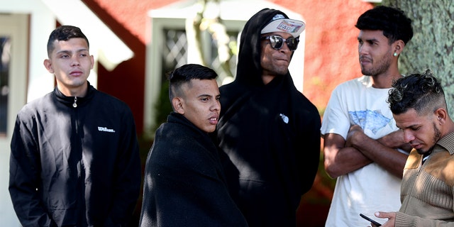 A handful of migrants are seen outside St. Andrews Episcopal Church Thursday on Martha's Vineyard in Massachusetts.