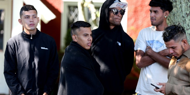 A handful of migrants are seen outside St. Andrews Episcopal Church Thursday on Martha's Vineyard in Massachusetts.