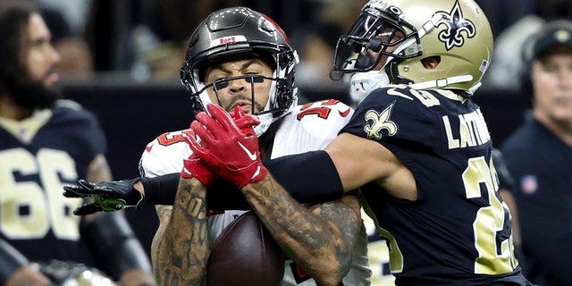 New Orleans Saints cornerback Marshon Lattimore breaks up a pass intended for Tampa Bay Buccaneers wide receiver Mike Evans during the first half in New Orleans on Sept. 18, 2022.