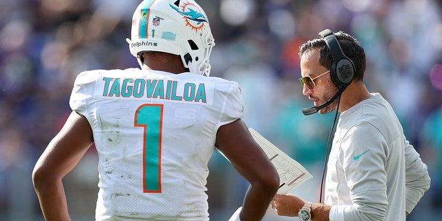 Miami Dolphins head coach Mike McDaniel talks to Tua Tagovailoa during the Ravens game, Sept. 18, 2022, in Baltimore.