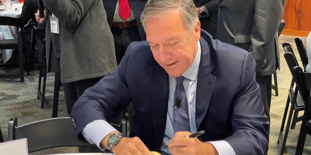 Former Secretary of State Mike Pompeo signs the iconic wooden eggs before addressing the "Politics and the Egg" speaking series at the New Hampshire Institute of Politics on September 20, 2022.