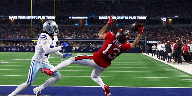 Mike Evans #13 of the Tampa Bay Buccaneers scores a touchdown ahead of Trevon Diggs #7 of the Dallas Cowboys during the second half at AT&amp;T Stadium on September 11, 2022, in Arlington, Texas.