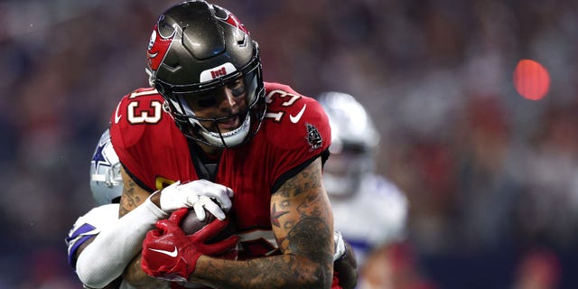 Mike Evans #13 of the Tampa Bay Buccaneers pulls in a pass against Anthony Brown #3 of the Dallas Cowboys during the second half at AT&T Stadium on September 11.