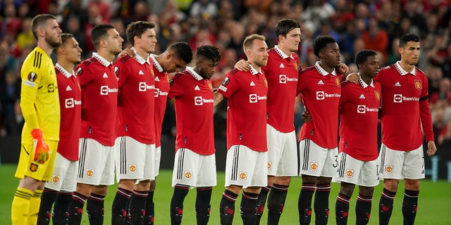 Manchester United players observe a minute of silence following the death of HRH Queen Elizabeth II, ahead of the group E Europa League soccer match between Manchester United and Real Sociedad at Old Trafford in Manchester, England, Thursday, Sept. 8, 2022.