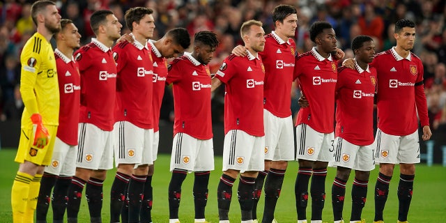 Manchester United players observe a minute of silence following the death of HRH Queen Elizabeth II, ahead of the group E Europa League soccer match between Manchester United and Real Sociedad at Old Trafford in Manchester, England, Thursday, Sept. 8, 2022.