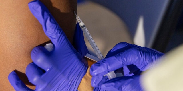 A science assistant administers a monkeypox vaccine at an immunization facility in Brooklyn, New York, Tuesday, August 30, 2022. 