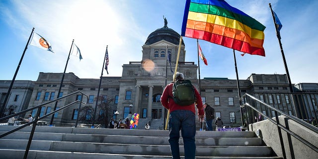 Demonstrators gather on the steps of the Montana State Capitol protesting anti-LGBTQ+ legislation.