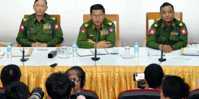 Major General Zaw Min Tun, right, says the shooting of a passenger plane in Myanmar was carried out by terrorists belonging to the Karenni National Progressive Party.