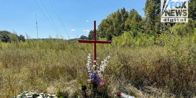 A cross set up near the power lines where Lyric Woods and Devin Clark were found death with gunshot wounds by a pair of ATV riders over the weekend.